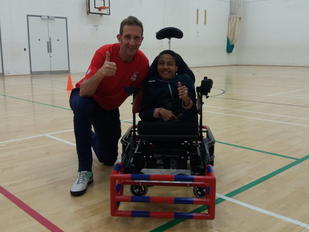 Powerchair footballer Joel with coach Michael Harrington