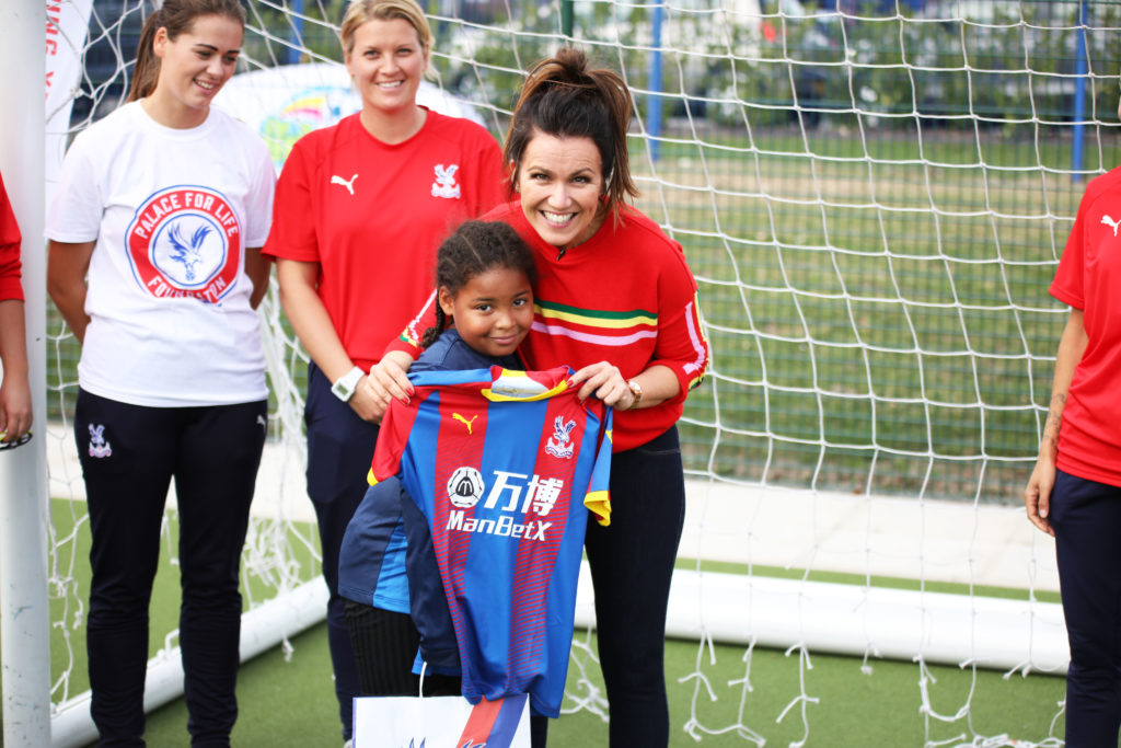 Susanna Reid receives a Palace shirt from a young fan